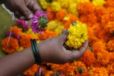 Photo: Threading flowers for offerings, by Meena Kadri
